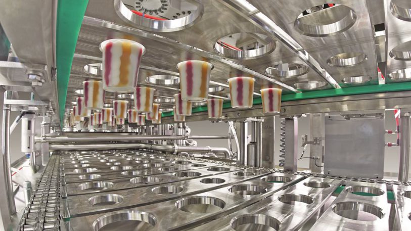 Blick in die vierbahnige Längsläufer-Becherfüllanlage FOODLINER 6.000 für die Abfüllung von fruchtunterlegten und geswirlten Milchprodukten.