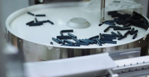 Der eCobra-Roboter führt der Maschine bis zu 2.500 Fläschchen pro Stunde zu. Sein Arbeitsradius beträgt 600 Millimeter. (Bild: Ganahl AG)