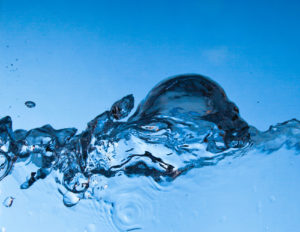 Tropfen Wasser auf blauem Hintergrund