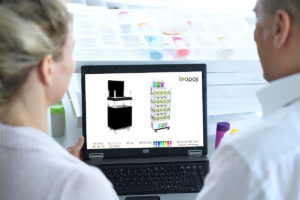 Eine Frau und ein Mann gestalten an einem Laptopbildschirm Displays