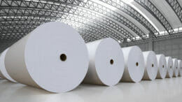 Image of big white paper rolls in a storage hall.