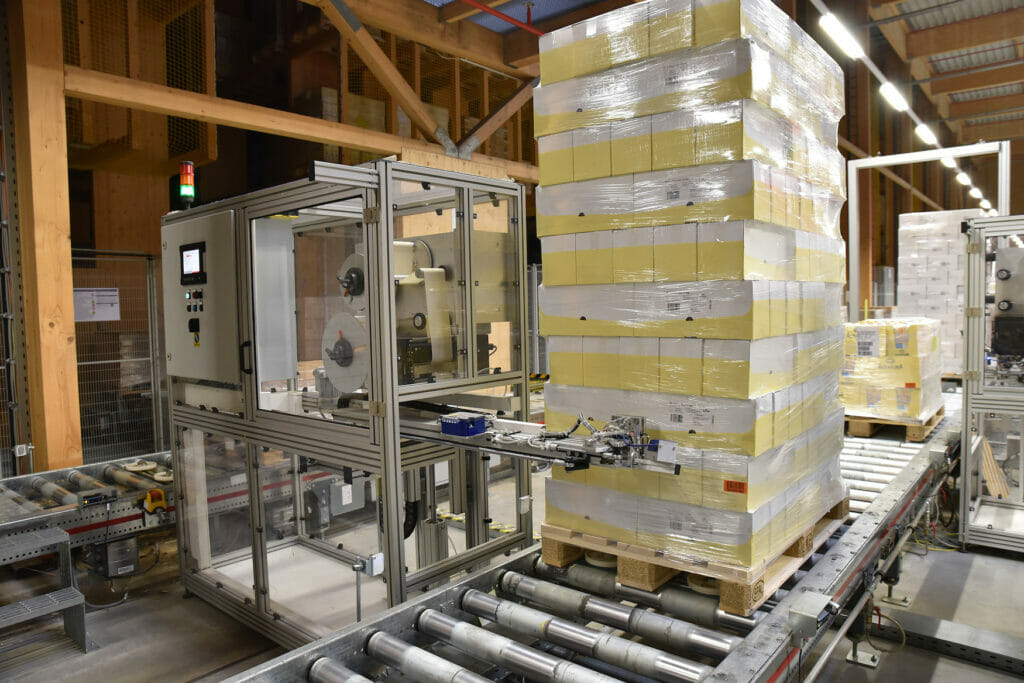 Bild von palettierten Produkten, die von einer Maschine gekennzeichnet werden.