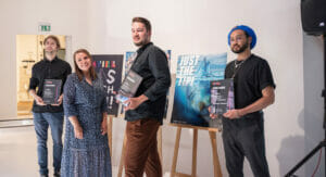 Picture of four people being awarded for their artworks