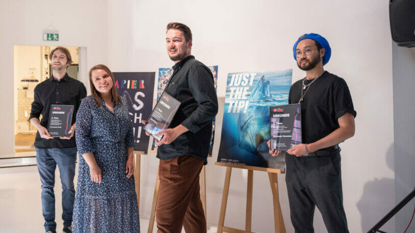 Picture of four people being awarded for their artworks