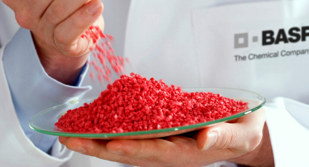 Picture of a hand dropping plastic particles onto a plate