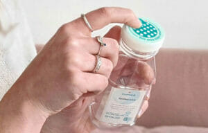 Image of a hand holding a plastic bottle