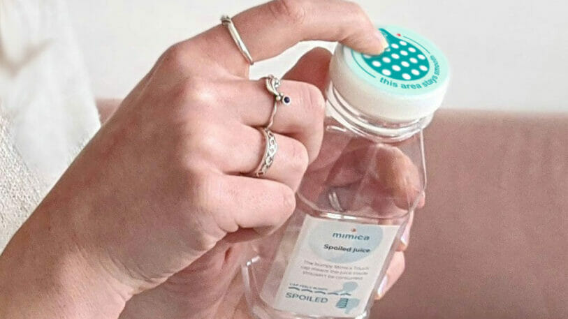 Image of a hand holding a plastic bottle