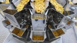 The CCW-RVE Enhanced multi-head weighers feed short pasta products into flow-wrapping machines positioned underneath.